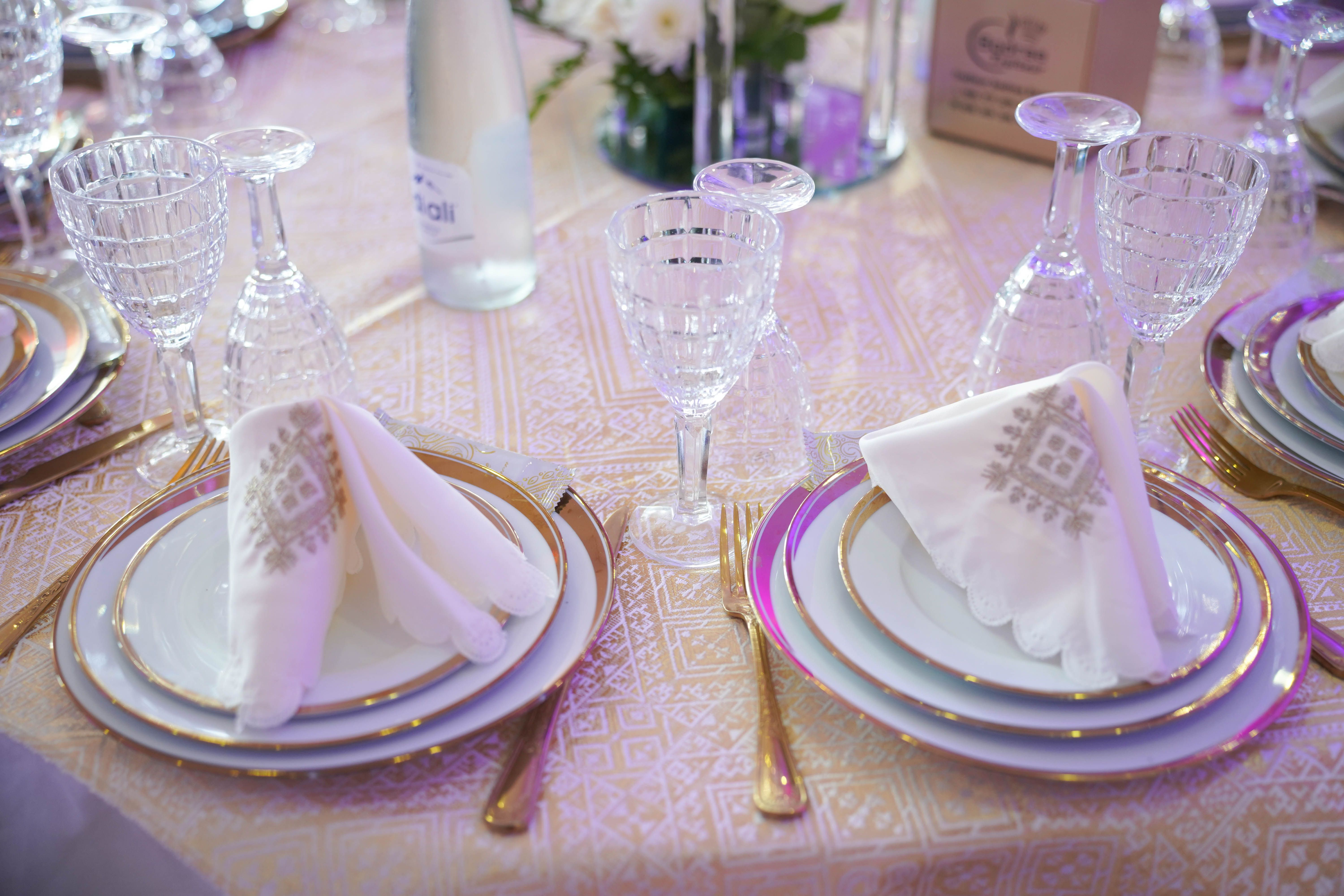 Beautifully arranged formal table setting with crystal glassware and ornate napkins for a special occasion