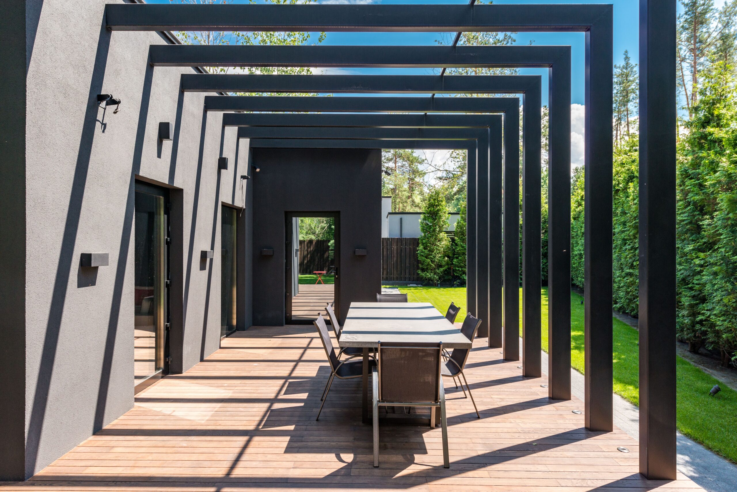 Contemporary backyard patio with a pergola and outdoor dining set